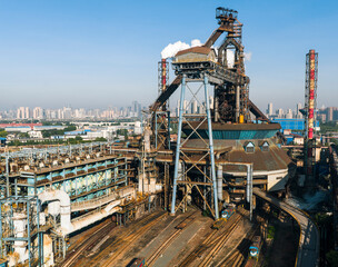 Fototapeta premium Aerial view of Wuhan steel plant, featuring a complex geometry of massive blast furnaces and intricate pipelines. It reflects China's industry and economy evolution, producing silicon steel for electr