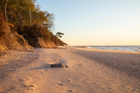 Dramatic cliff on the beach in Dziwnowek, Poland, at sunset