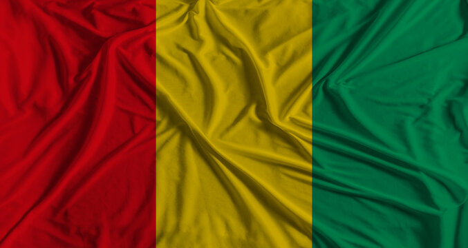 Guinea flag with fabric texture background. National flag of Guinea with cloth texture