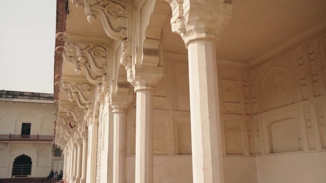 Stunning colonnade with ornate arches and carved details inside the Diwan-I-Am, or Hall of Audience, at the historic Agra Fort, a UNESCO World Heritage site in Uttar Pradesh, India