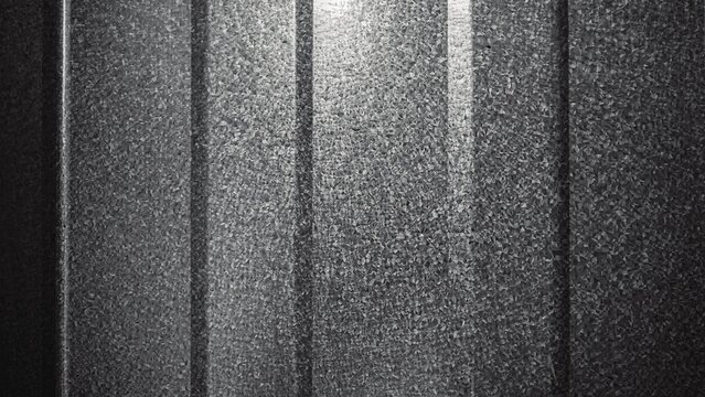 Textured dark grey metal panel background with grainy metallic surface