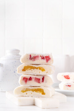 Viral rice paper mochi with fresh summer fruits and greek yogurt. Healthy diet summer dessert made with sticky rice paper, yogurt, strawberries, apricots, peaches. Modern simple recipe of asian mochi