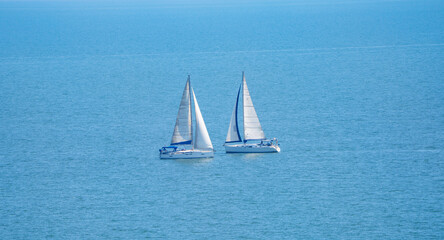 Fototapeta premium White sailboats on the blue sea 