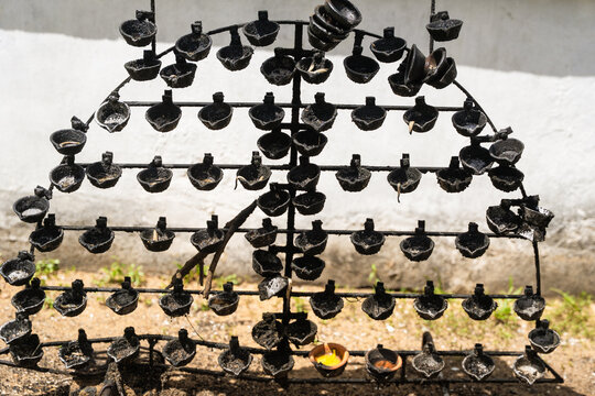View of traditional oil lamps on a metal stand at the Japanese Peace Pagoda - Rumassala in Unawatuna, Southern Province, Sri Lanka.