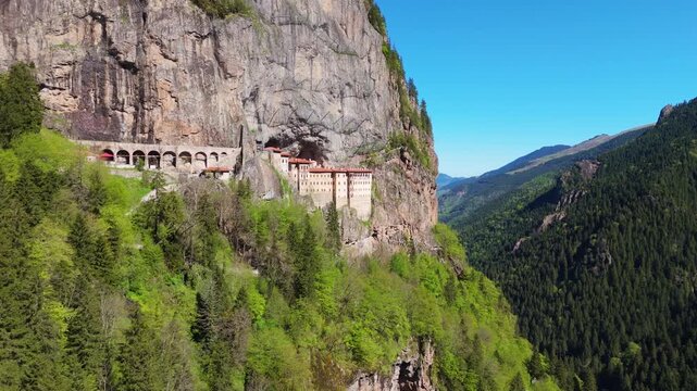 Sumela Monastery, Trabzon. Drone view of the historic white stone site tightly to a steep rock wall above a green valley Turkey travel destination