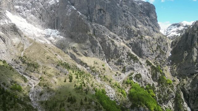 Aerial drone footage over Rifugio Settimo Alpini, Italy: dramatic Dolomite peaks, alpine landscape and remote mountain scenery under clear light. Ideal for nature and travel projects.