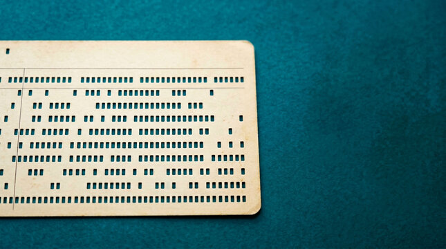 Single vintage computing punch card with rectangular hole pattern on teal background, early computer programming and data storage concept.