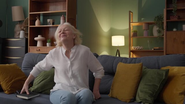 Happy Mother And Daughter Hugging On Sofa In Cozy Living Room