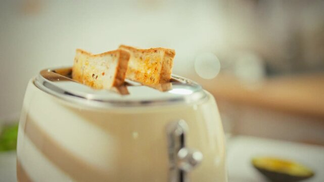 In a retro kitchen, a vintage toaster pops a slice of bread into crisp toast, the hot coils flashing as the cooking process finishes, highlighting classic breakfast technology in the morning