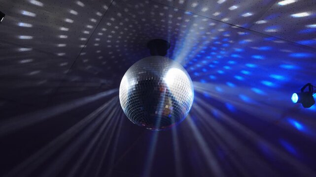 Disco ball reflects light and creates patterns in a room