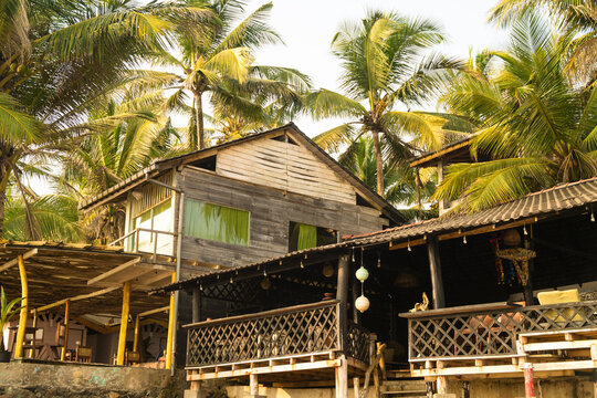 View of a rustic wooden beach house nestled among tropical palm trees in Galle, Southern Province, Sri Lanka.