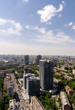 Modern high rise building in Kyiv with wavy glass facade, aerial cityscape photography under blue sky Ukraine