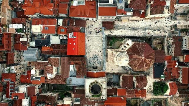 Cinematic aerial drone footage of Split featuring the Adriatic coastline, historic old town, marina, and Mediterranean atmosphere. Ancient architecture mixed with modern coastal life