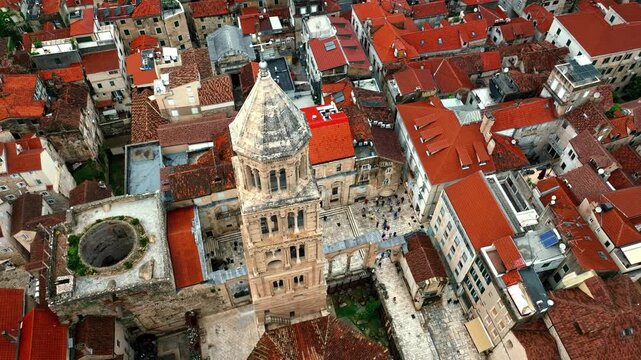 Cinematic aerial drone footage of Split featuring the Adriatic coastline, historic old town, marina, and Mediterranean atmosphere. Ancient architecture mixed with modern coastal life
