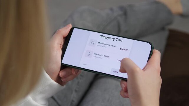 Viewing a mobile shopping cart with two items: Modern Headphones and a Minimalist Watch. Total value displayed before applying a discount. Perfect for online retail, consumer behavior, and digital