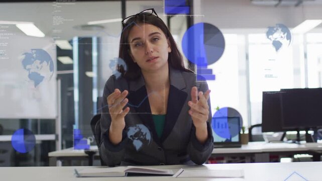 Woman gesturing outward, presenting business data overlays growing, holding pen, coworker on phone