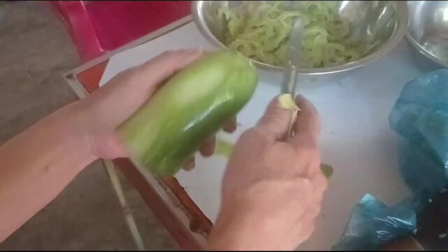 Hand Peeling Fresh Winter Melon for Home Cooking