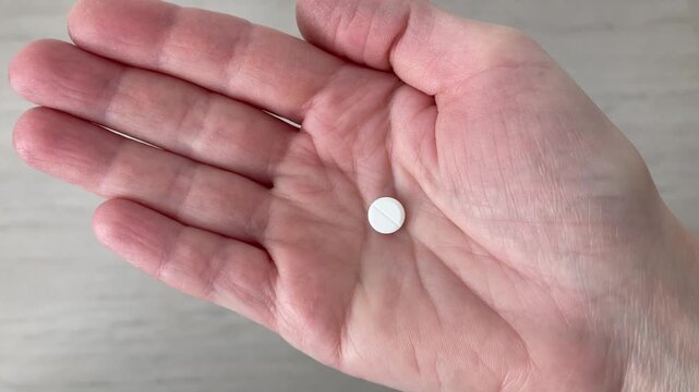 The woman takes pill from her palm. Symptoms of seasonal allergies. Drug that reduces runny nose, itching and lacrimation, return of comfort and the opportunity to lead a habitual lifestyle. Top view