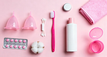 Naklejka premium Feminine hygiene and personal care items including menstrual cups, cotton buds, toothbrush, medication, and towel
