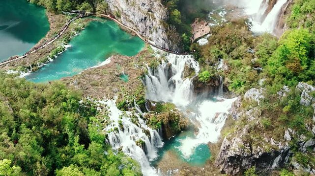 Cinematic footage of Plitvice Lakes National Park in Croatia featuring turquoise lakes, cascading waterfalls, wooden pathways, and lush forest landscapes