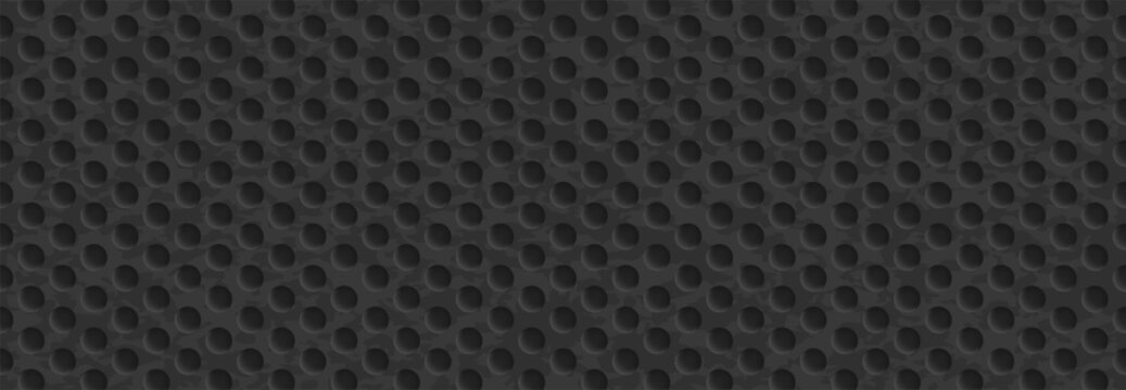 Large circular perforations in dark mesh creating a strong textured industrial surface with depth.