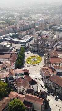 Vertical aerial orbit of Carlos de Amarante square and Igreja de S&atilde;o Marcos in Braga, Portugal.