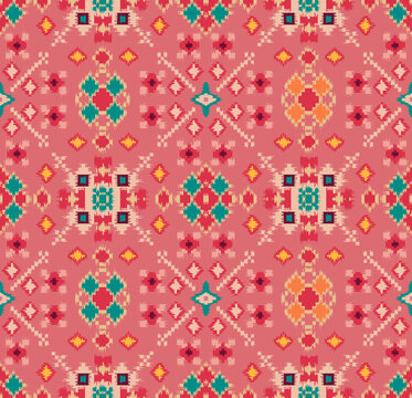 Seamless traditional patola ikat pattern with geometric ethnic motifs on pink background for textile print.