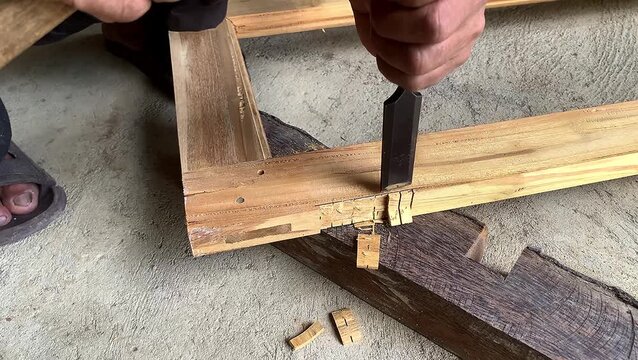Hand chisels wood with precision and care. manual handwork.