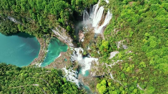Cinematic footage of Plitvice Lakes National Park in Croatia featuring turquoise lakes, cascading waterfalls, wooden pathways, and lush forest landscapes