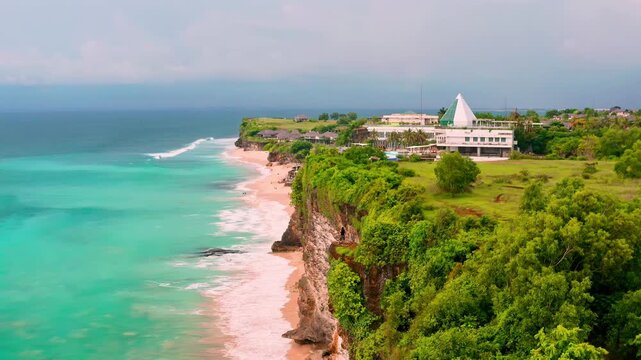 Aerial drone view of Dreamland beach scenic limestone cliffs and turquoise ocean waves, Bali 4K