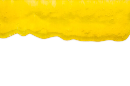 Yellow liquid transparent gel dripping down against white background.