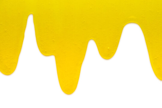 Yellow liquid transparent gel dripping down against white background.