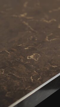 Vertical video. featuring a black granite countertop in a modern kitchen interior with polished natural stone texture and luxury contemporary design. Stylish dark stone surface with refined