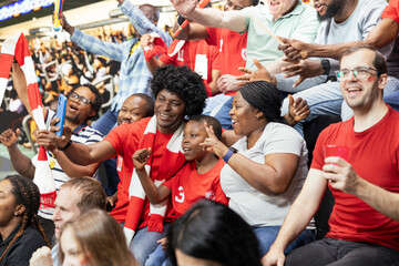 Fototapeta premium Mother and father take photos of first match with their son at the stadium, enjoying sports family fun with child fan at a live football game full of cheering supporters. Passionate stadium crowd.