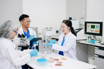 Fototapeta premium Dynamic scene of food scientists using microscopes and pipettes in a lab,