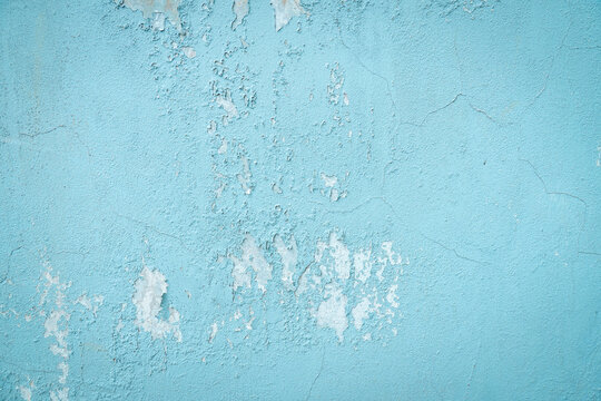 Blue peeling wall texture background with weathered paint surface and abstract grunge pattern detail. Rustic vintage backdrop for industrial design, construction, and artistic concepts.