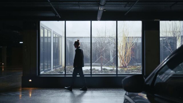 Silhouettes of two people making an illegal exchange of a suitcase for money in a dark parking lot