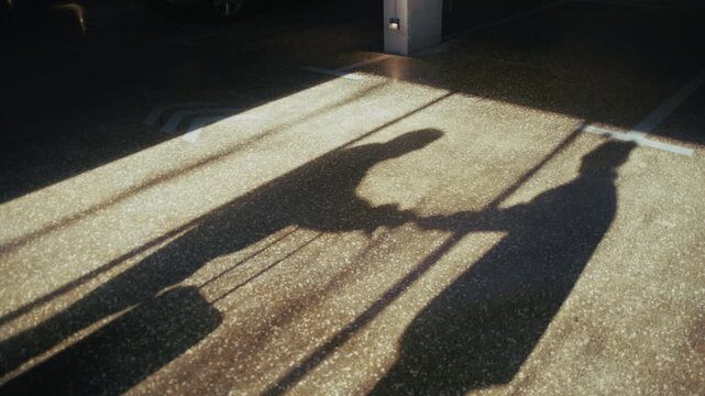 Two shadowy figures meet between parked cars at night, exchanging a suitcase for a thick envelope of money.