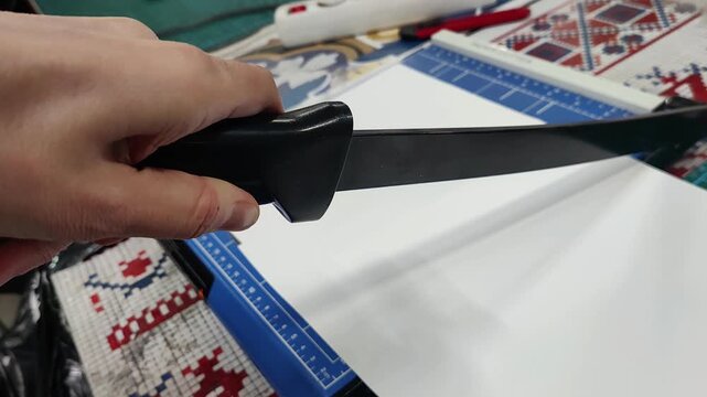 cutting paper on a manual guillotine