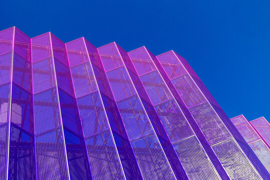 Modern purple metal facade panels against clear blue sky