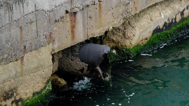 Sewage Pipe Discharging Wastewater into Sea. Wastewater Flowing into Sea Environmental Pollution. Dirty Water Discharge into Ocean Pollution Scene.