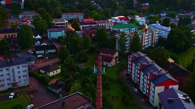 Small European town with residential buildings and a repurposed brick chimney