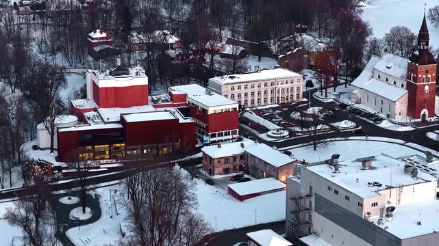 Valmiera, Latvia, showing St. Simon's Church, city hall, and theater building covered in winter snow