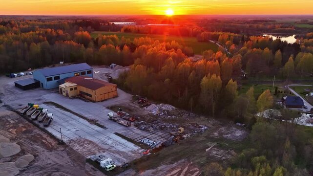 Rural industrial area during a beautiful and colorful sunset in picturesque aerial view