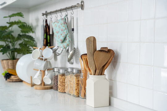 Assortment of grains, cereals and pasta in glass jars and white glass drinking set equipment on the kitchen on white table. Flat lay, Concept of food preparation, kitchen on background.