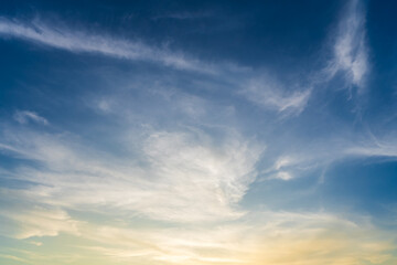 Obraz premium Twilight blue bright and orange yellow dramatic sunset sky in countryside or beach colorful cloudscape texture with white clouds air background.