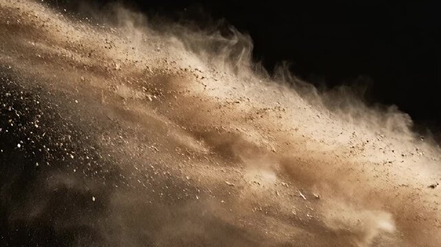 Abstract slow motion of sand particles against a black background