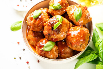 Fototapeta premium Meatballs in tomato sauce in iron plate on black background.