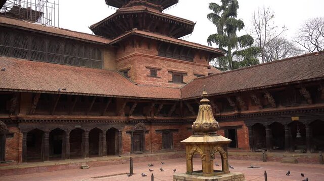Kathmandu, Nepal - 15 January 2024: View of the historic courtyard at Kathmandu Durbar Square with traditional Newari architecture and a central stone shrine.