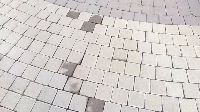 Top view of the surface of a pedestrian path with paving slabs. New cobblestone pavement close up. Traditional stone pavement. 